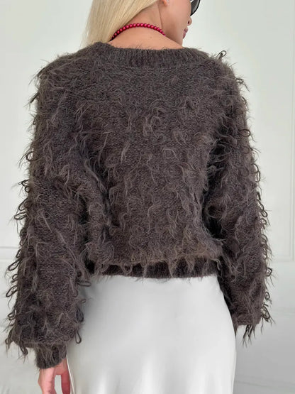 Espresso Cardigan from Lauven, showcasing a cropped, oversized brown bouclé knit with playful feathered fringe.