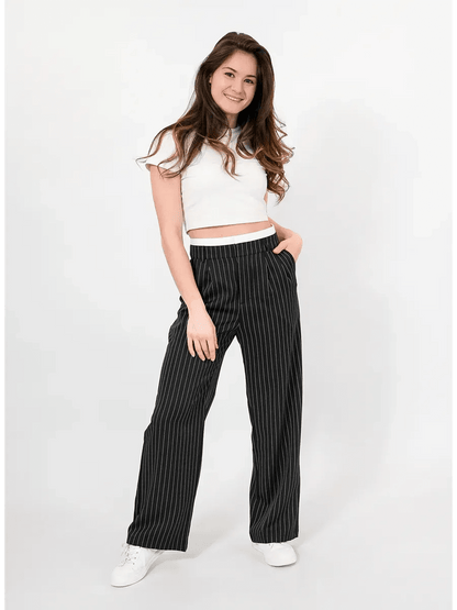 Model wearing Lauven Orion Pinstripe Pants featuring a high-waist wide-leg design and elegant pinstripes.