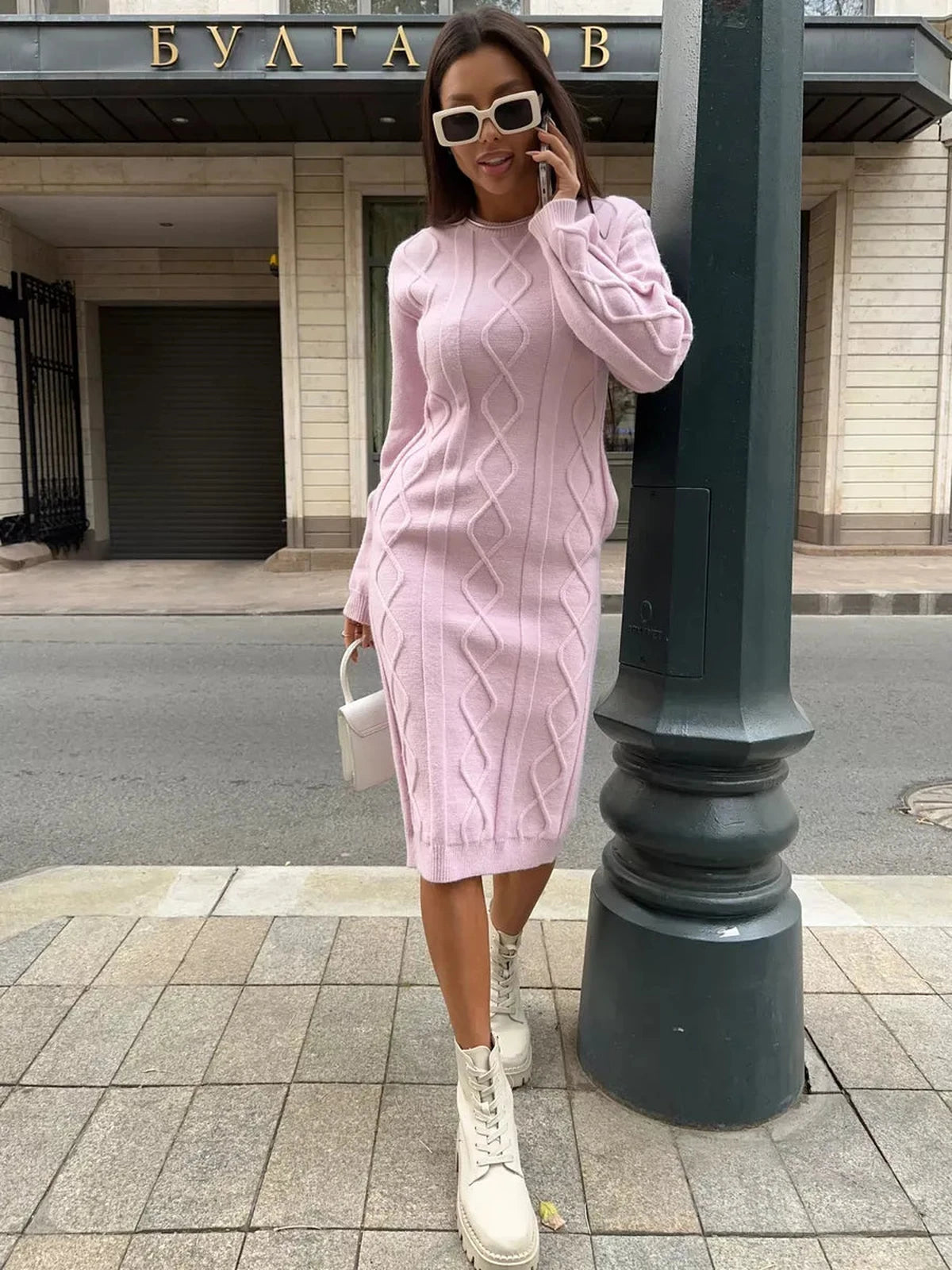 Luna Midi Dress by Lauven, soft pink textured knit sweater dress on a model in urban setting.