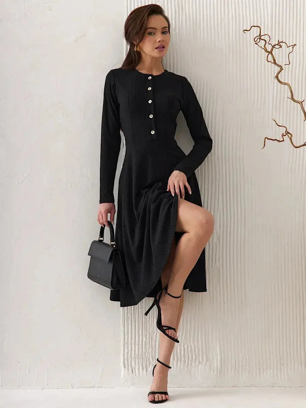Serene Grace Midi Dress in black ribbed fabric, featuring decorative buttons and a stylish flared skirt.