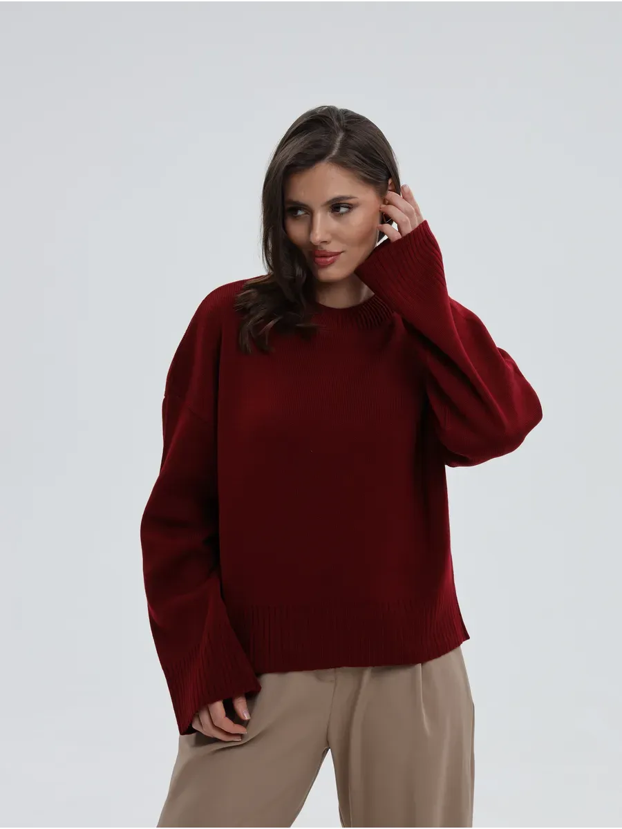 Model wearing Valora Sweater by Lauven in burgundy red, showcasing oversized knit design and stylish comfort.