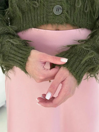 Olive Cardigan by Lauven featuring cozy cropped design and feathered fringe details, hands showing the textured knit sleeves.