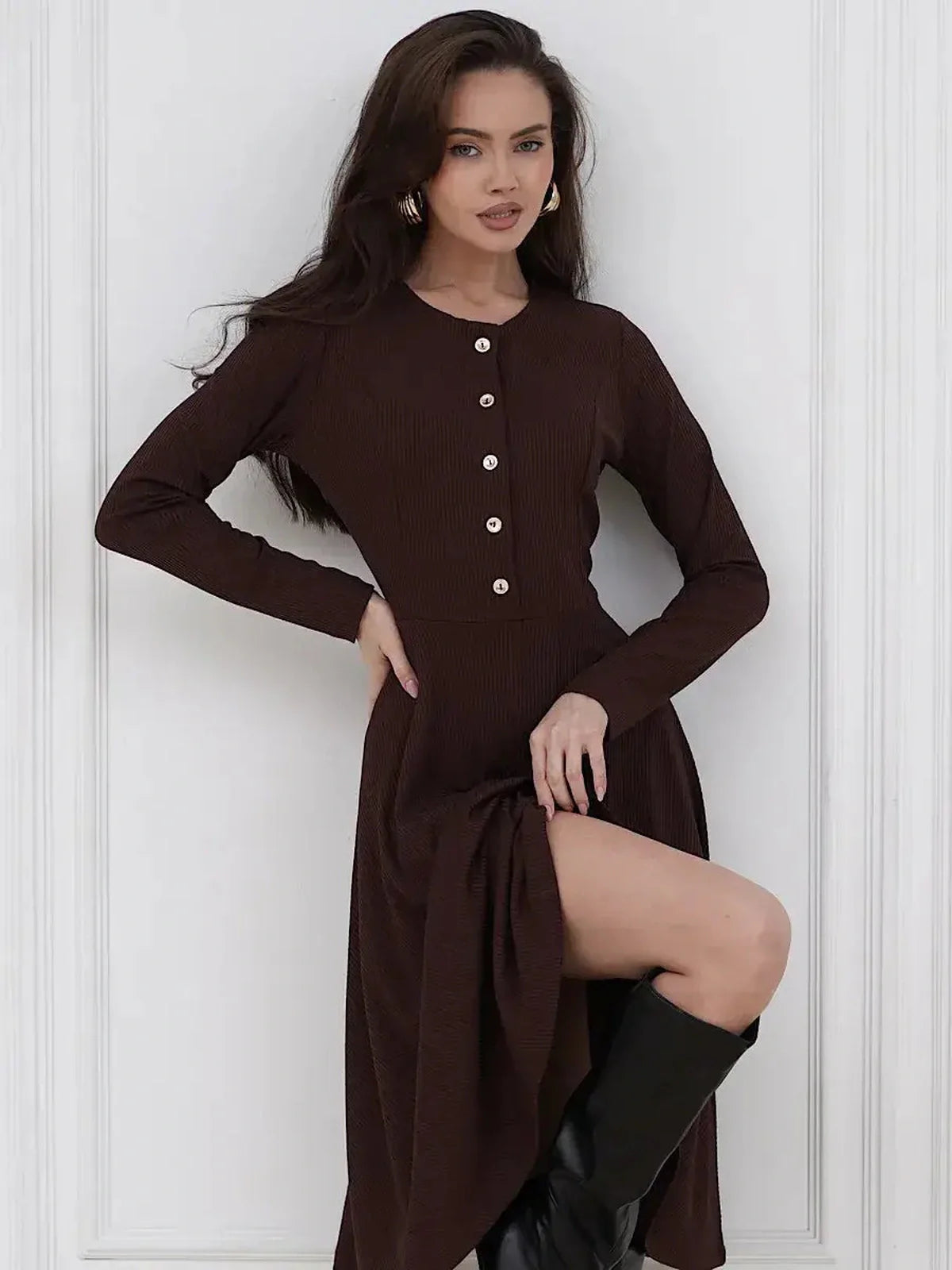 Model wearing a refined brown Midi Dress Noirette, featuring button detailing and a flattering fit-and-flare silhouette.