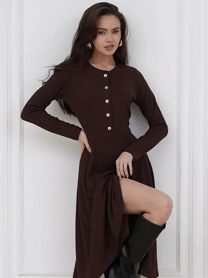 Model wearing a refined brown Midi Dress Noirette, featuring button detailing and a flattering fit-and-flare silhouette.