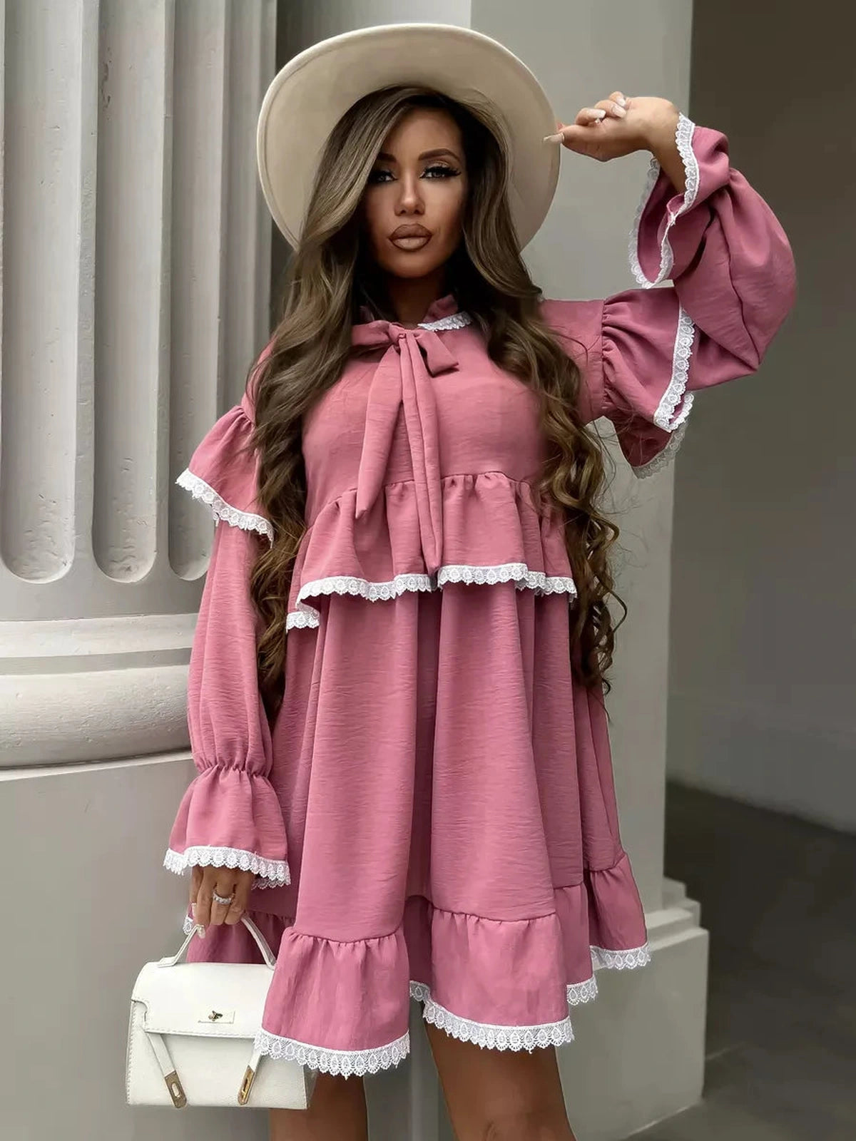 Lauven Rosea Mini Dress featuring elegant ruffles and lace detail in soft pink, perfect for feminine sophistication.