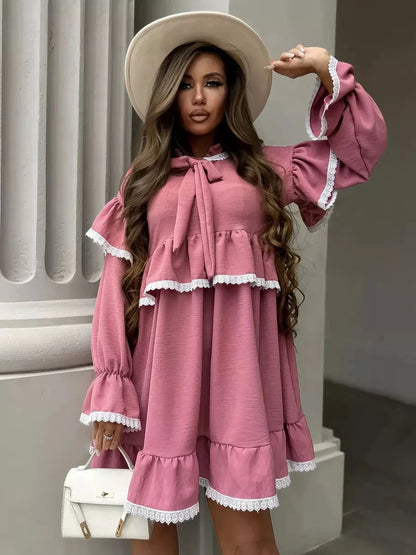 Lauven Rosea Mini Dress featuring elegant ruffles and lace detail in soft pink, perfect for feminine sophistication.