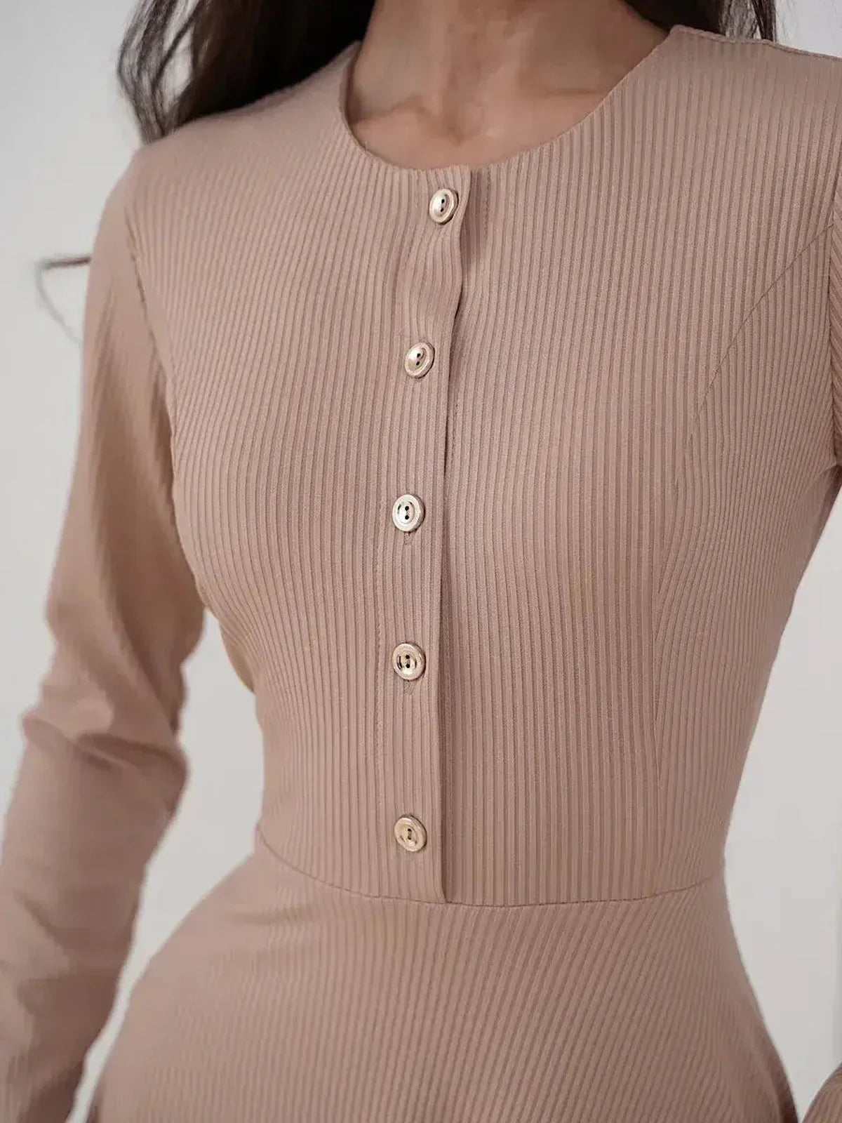 Close-up of the Sculpted Ease Midi Dress featuring ribbed knit texture and gold-tone button accents in beige.