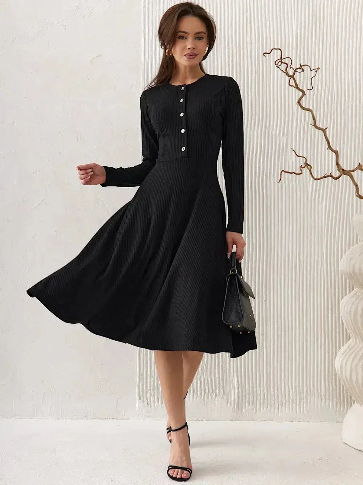 Serene Grace Midi Dress, a black ribbed silhouette with buttons, striking a balance between elegance and sophistication.