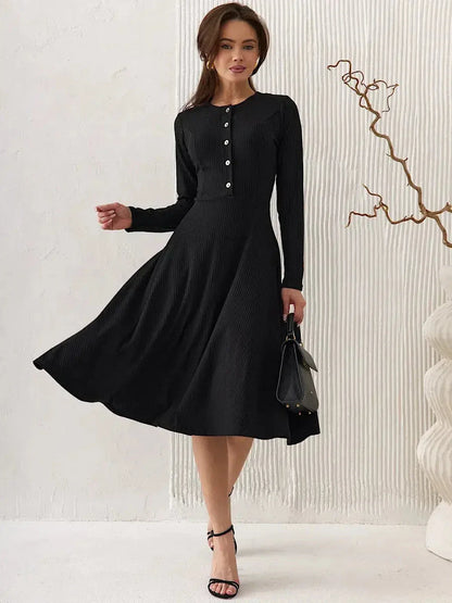 Serene Grace Midi Dress, a black ribbed silhouette with buttons, striking a balance between elegance and sophistication.