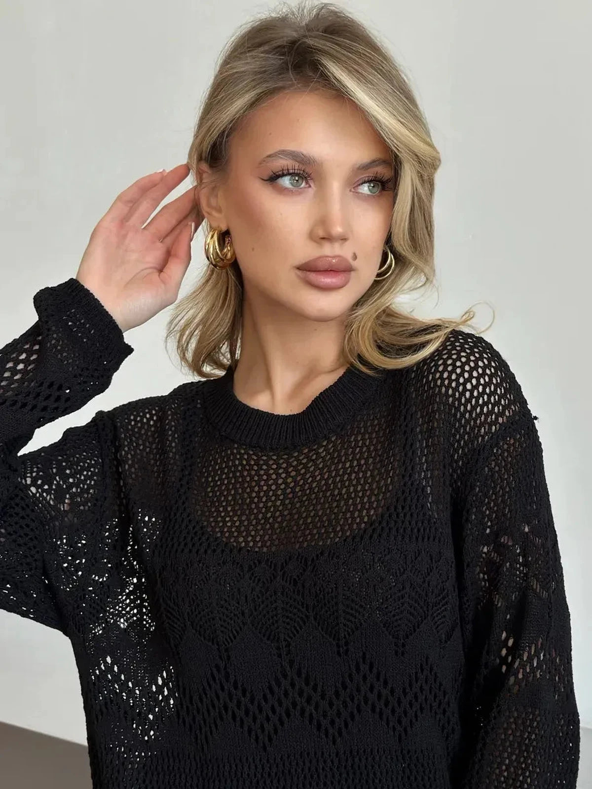 Chic model wearing the Lunara Maxi Dress by Lauven, showcasing elegant black crochet knit for summer evenings.