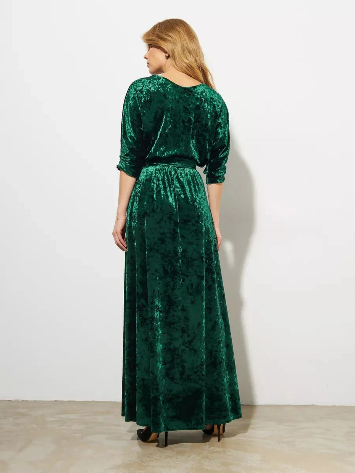 Back view of Emerelle Maxi Dress by Lauven in emerald green crushed velvet, showcasing its elegant A-line silhouette.