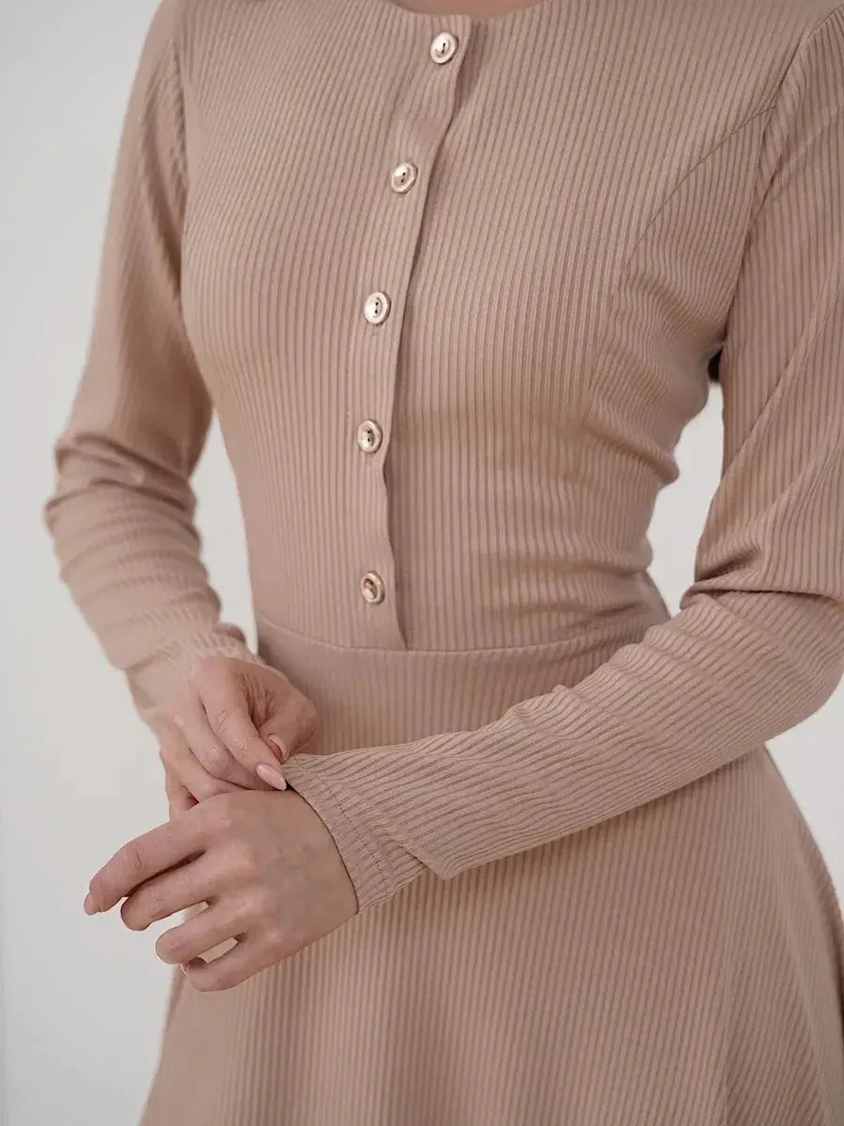 Sculpted Ease Midi Dress in ribbed knit with button accents, showcasing a refined waistline in soft beige.