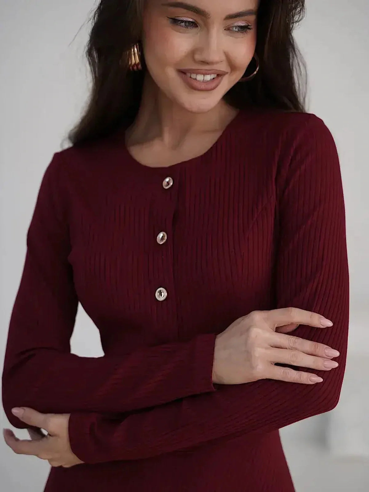 Crimson Grace Midi Dress with ribbed texture and gold button detail, modeled by a smiling woman.