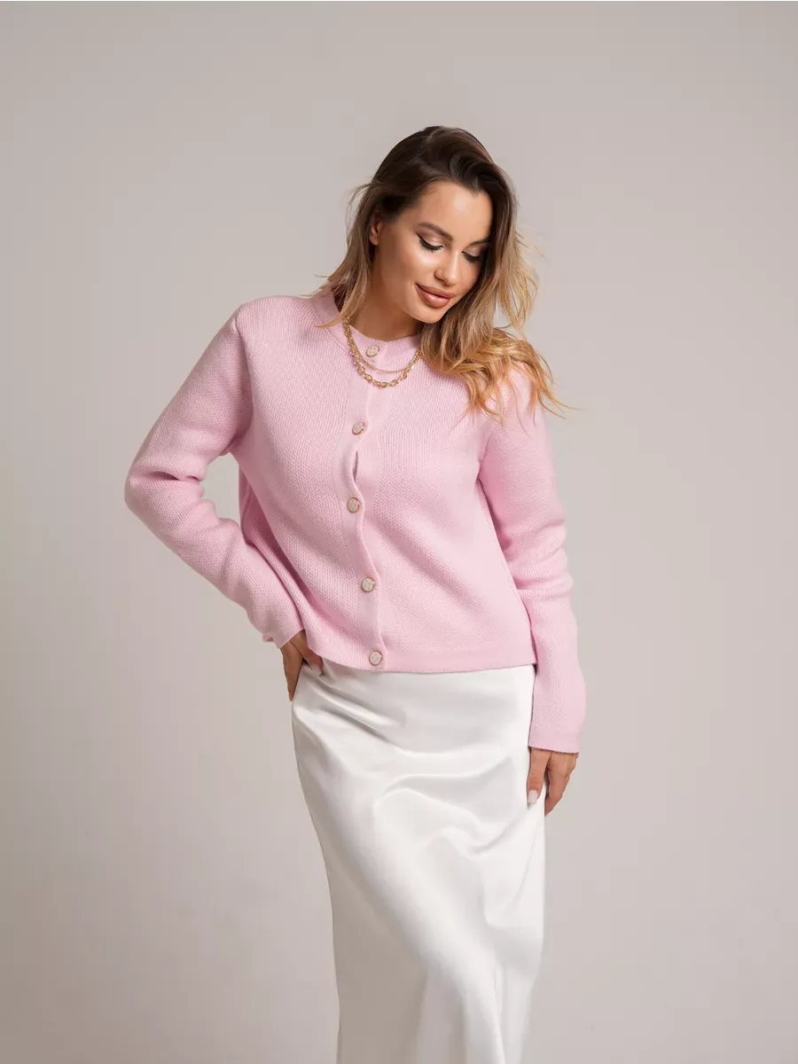 Stylish woman wearing a Lauven Blush Cardigan, a pink short loose fit knit with decorative buttons.