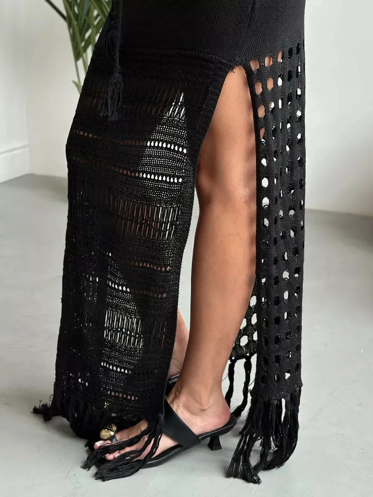 Vespera Maxi Dress featuring a dramatic side slit and fringe hem, showcasing its modern knit texture by Lauven.