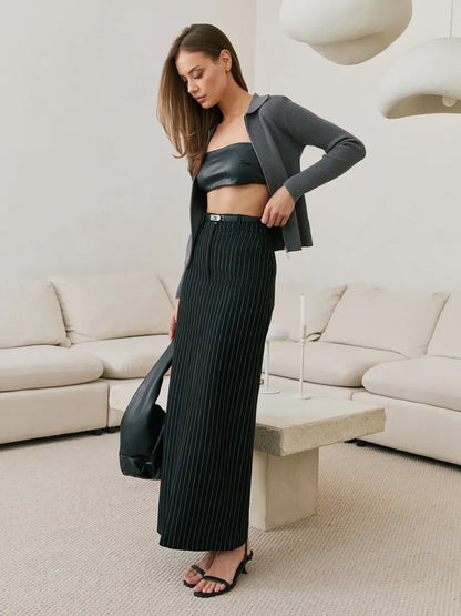 Orion Cardigan by Lauven in dark gray, styled with a black leather crop top and black pleated skirt.