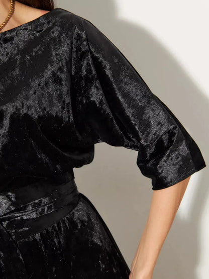 Close-up of the Noiré Maxi Dress by Lauven, featuring luxurious black crushed velvet and elegant A-line silhouette.