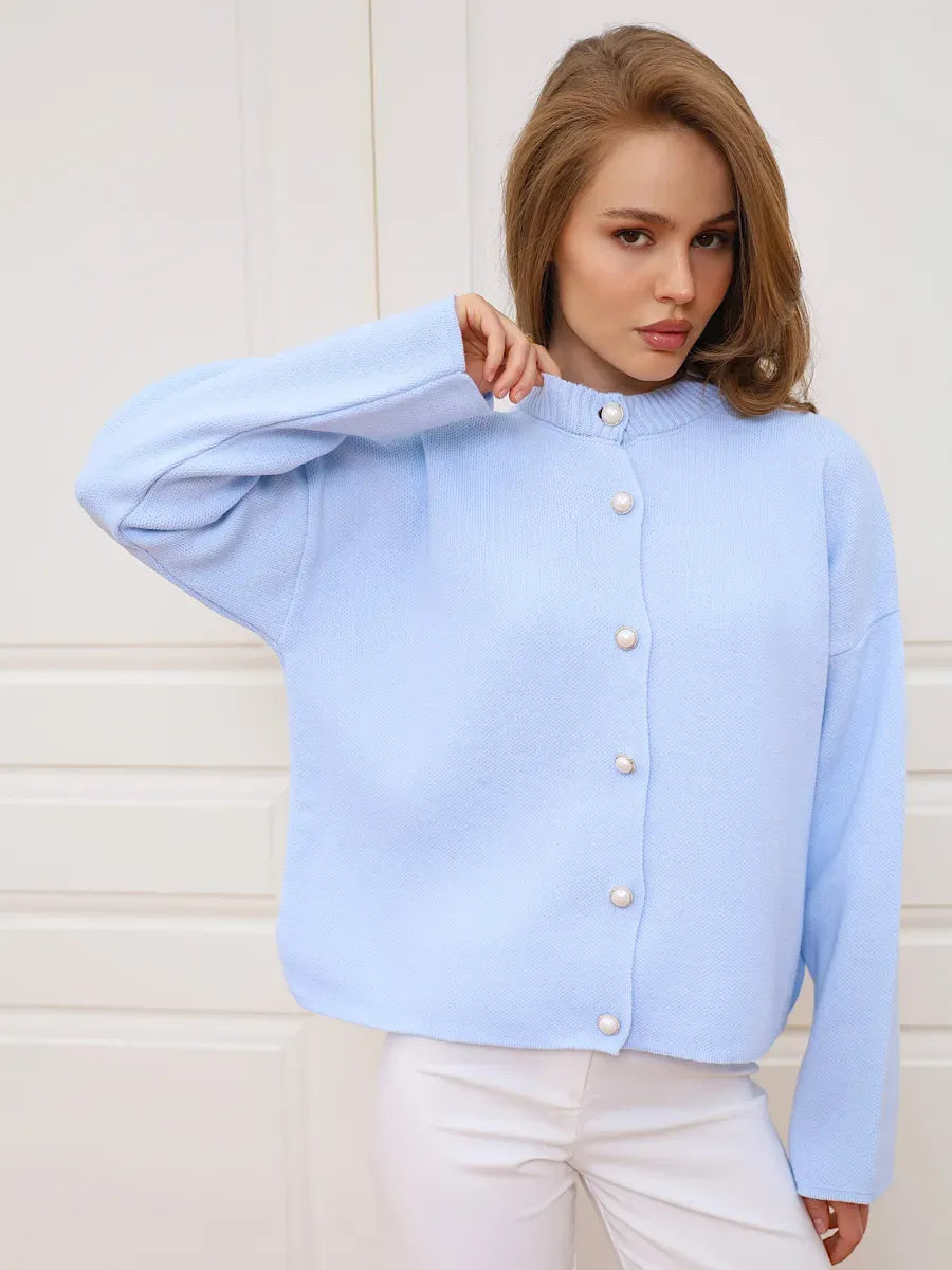 Model wearing the Skyline Cardigan by Lauven, a cozy light blue knit with button closure and a cropped silhouette.