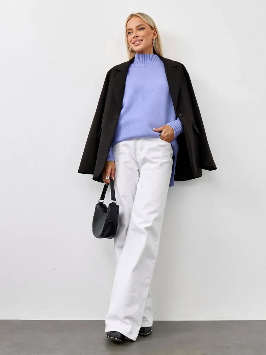 Lilac Sweater by Lauven styled with a black coat and white pants on a model, showcasing oversized lavender cashmere knitwear.