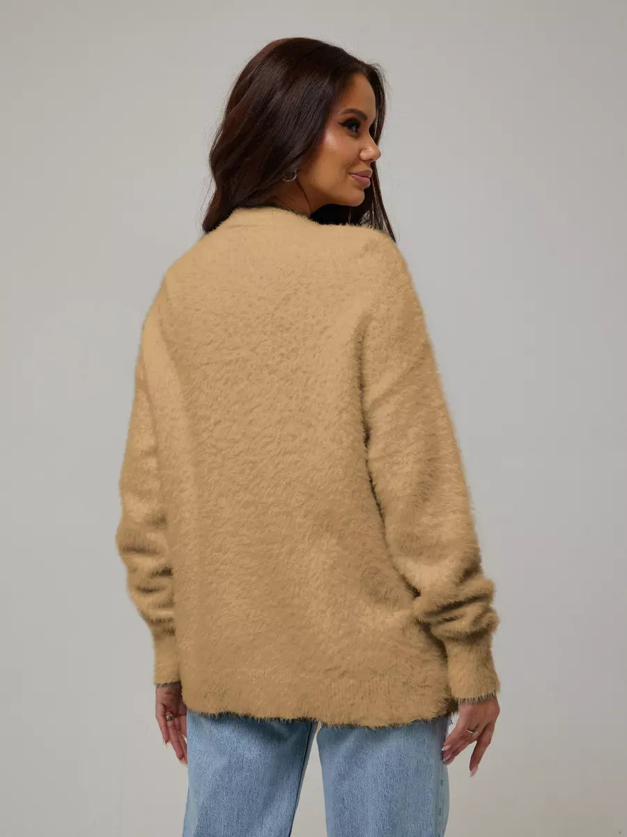 Woman wearing the Camelia Cardigan by Lauven, showcasing plush camel oversized knitwear from the back.