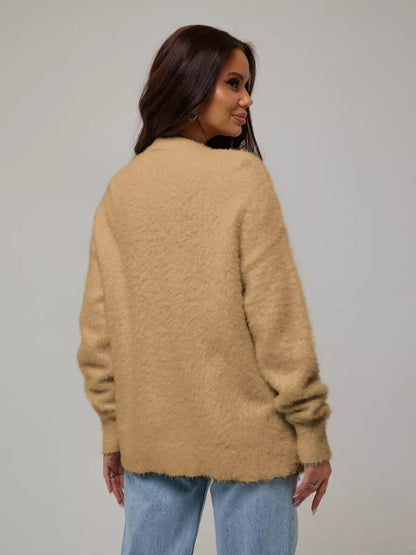 Woman wearing the Camelia Cardigan by Lauven, showcasing plush camel oversized knitwear from the back.