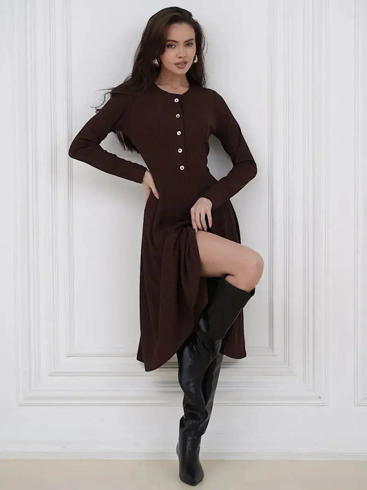 Elegant brown midi dress with button detailing and a stylish slit, paired with knee-high black boots for a chic look.