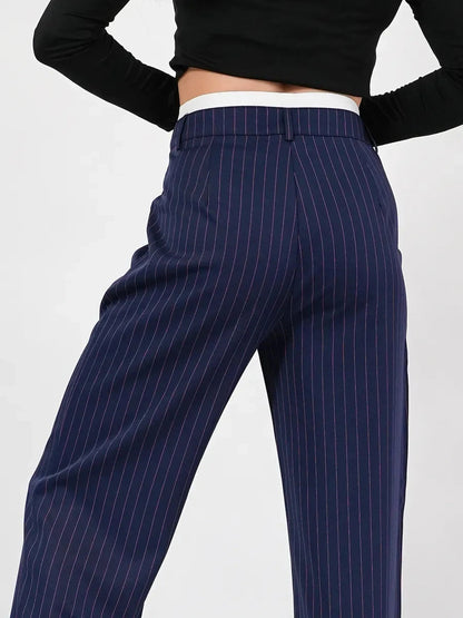 Aster Pants by Lauven featuring a high-waist, wide-leg silhouette in navy with elegant pinstripes.