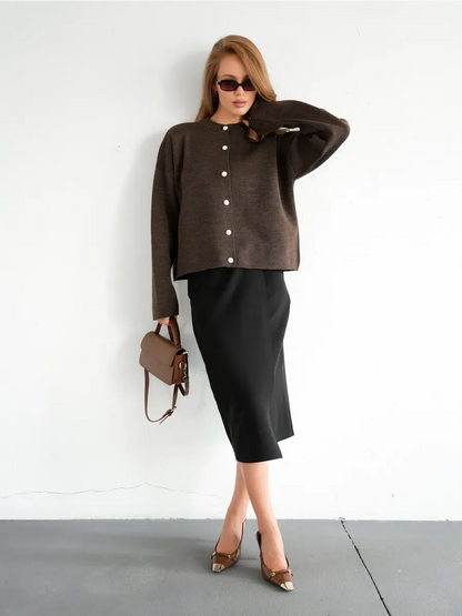 Cocoa Cardigan from Lauven: Warm brown knitwear with button closure, styled with a black skirt and accessories.