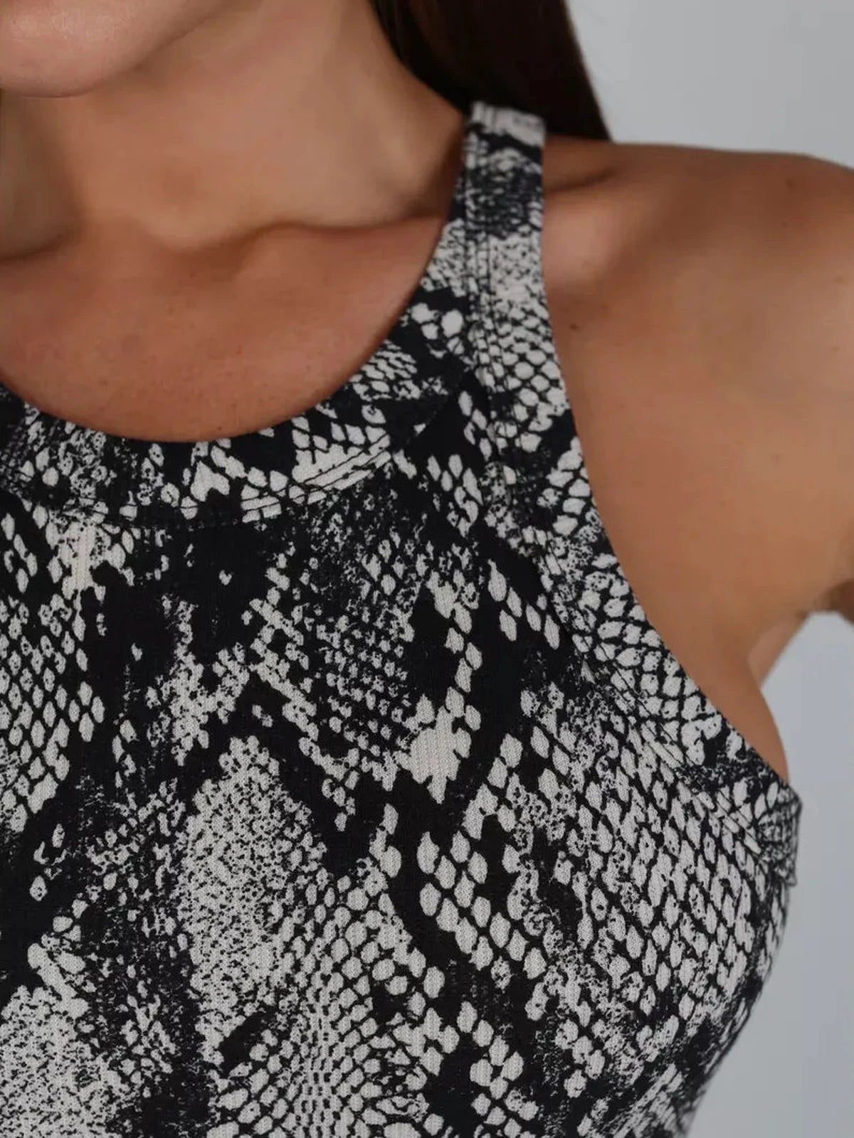 Close-up of the Nerine Maxi Dress by Lauven featuring a stylish snakeskin print and elegant neckline design.
