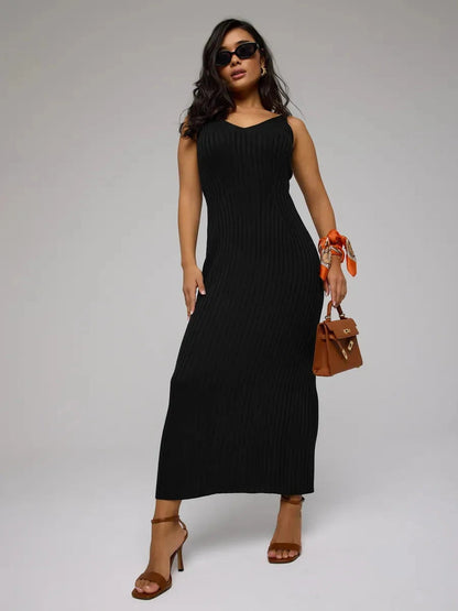 Woman wearing Noir Maxi Dress by Lauven, a sleek black ribbed knit dress, perfect for any elegant occasion.