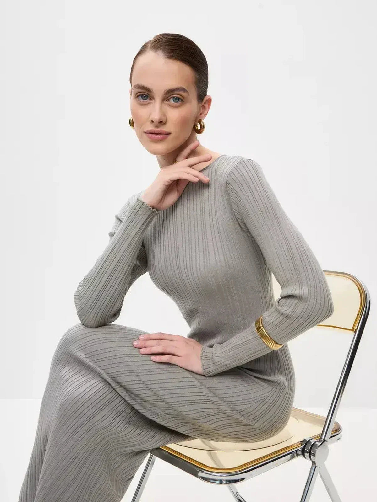 Model showcasing the Sculpted Grace Maxi Dress in soft ribbed knit, highlighting its elegance and sculptural fit.