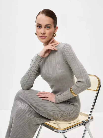 Model showcasing the Sculpted Grace Maxi Dress in soft ribbed knit, highlighting its elegance and sculptural fit.