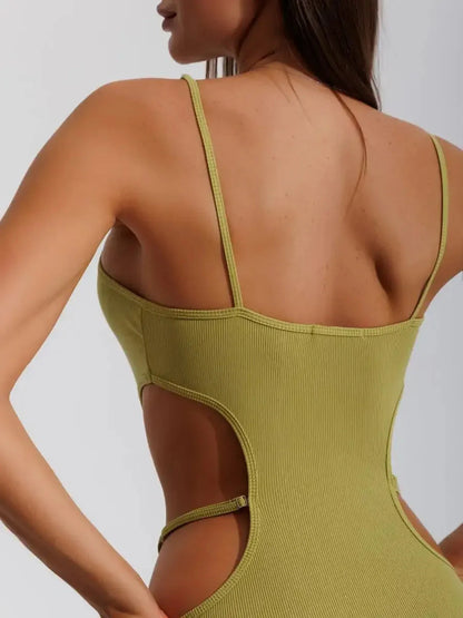 Back view of a woman wearing a pistachio Sculpt Cutout Midi Dress showcasing the sleek rib knit and side cut-outs.