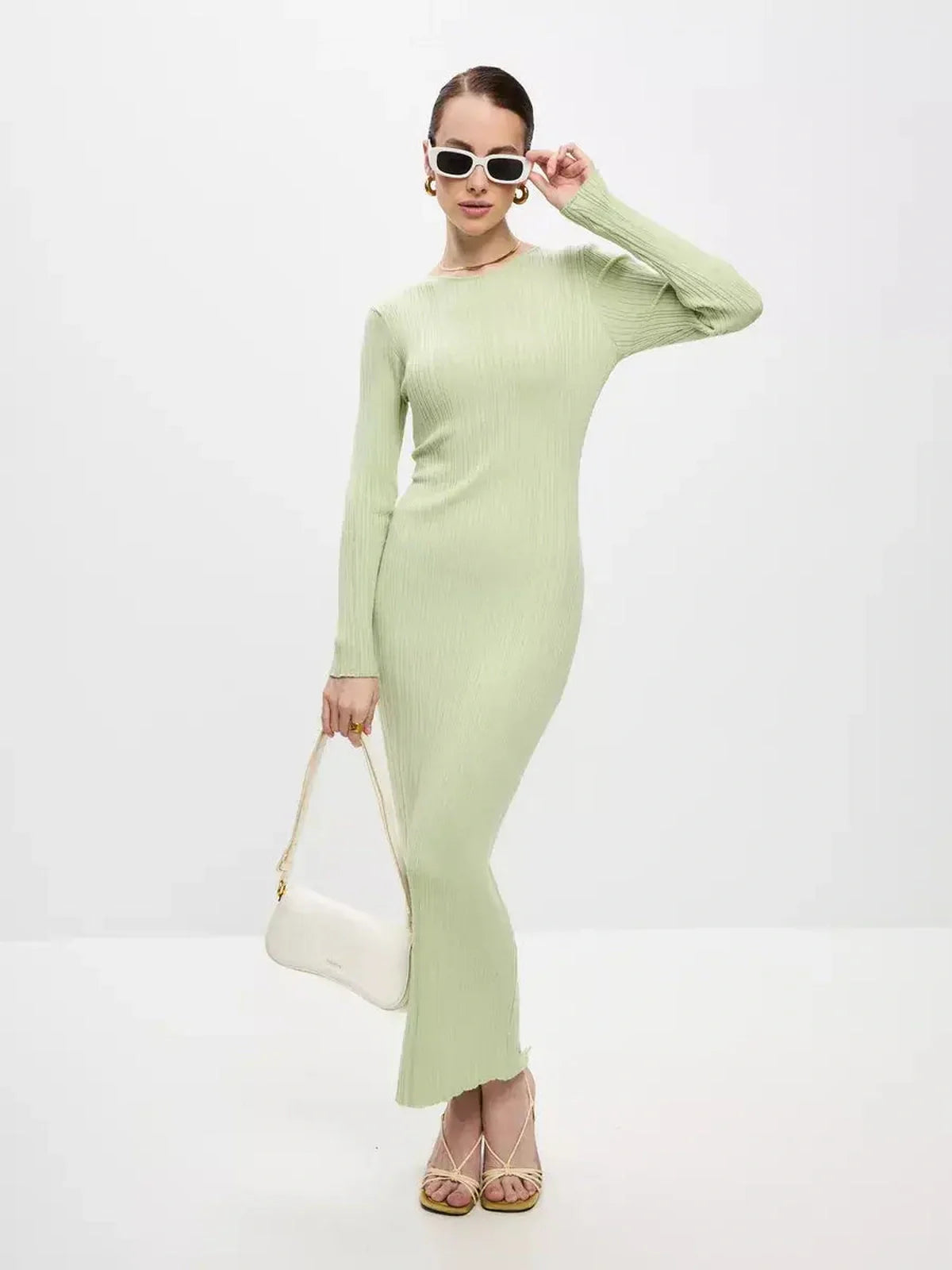 Model showcasing the Celery Luxe Maxi Dress in light green, featuring a ribbed design and seamless elegance.