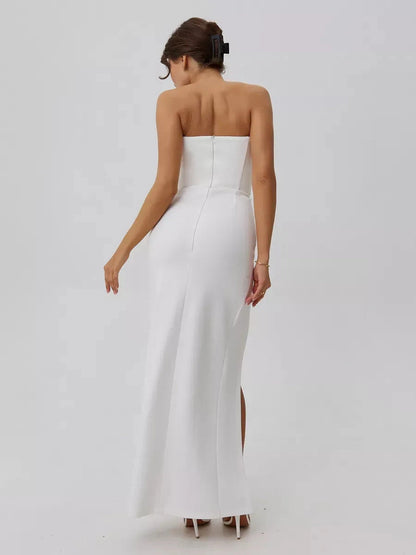 Lunaria Maxi Dress by Lauven, showcasing a minimalist design with a stunning front slit and sculpted fit in pristine white.