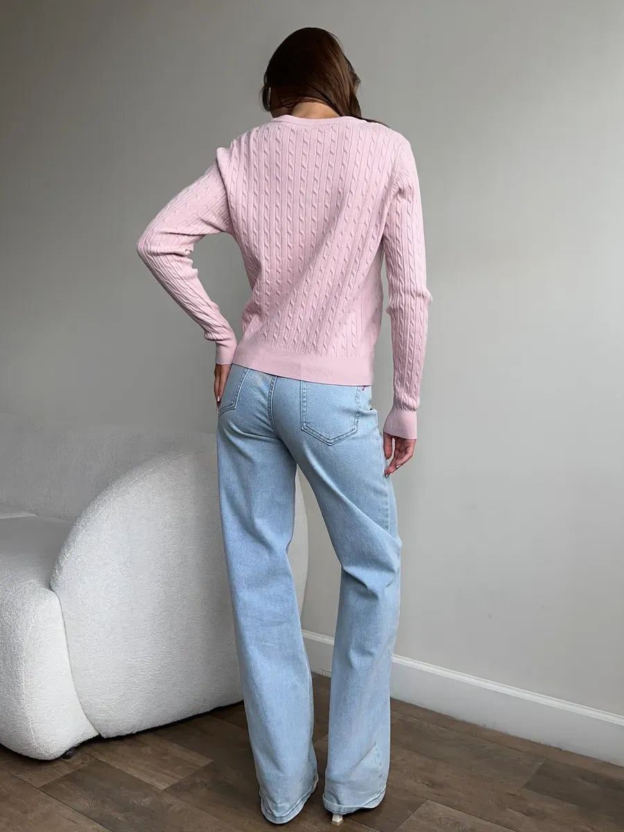 Back view of a model wearing the lightweight Rosewood Cardigan by Lauven, styled with light blue jeans.