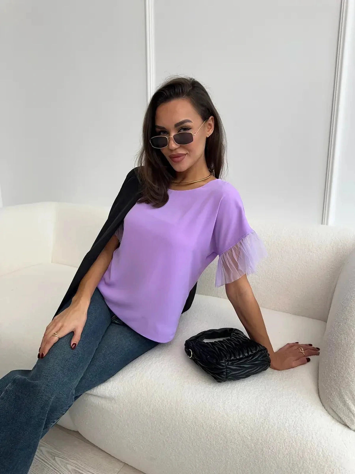 Lavande Blouse by Lauven modeled by a woman in lilac short sleeve blouse with sheer ruffle detail.