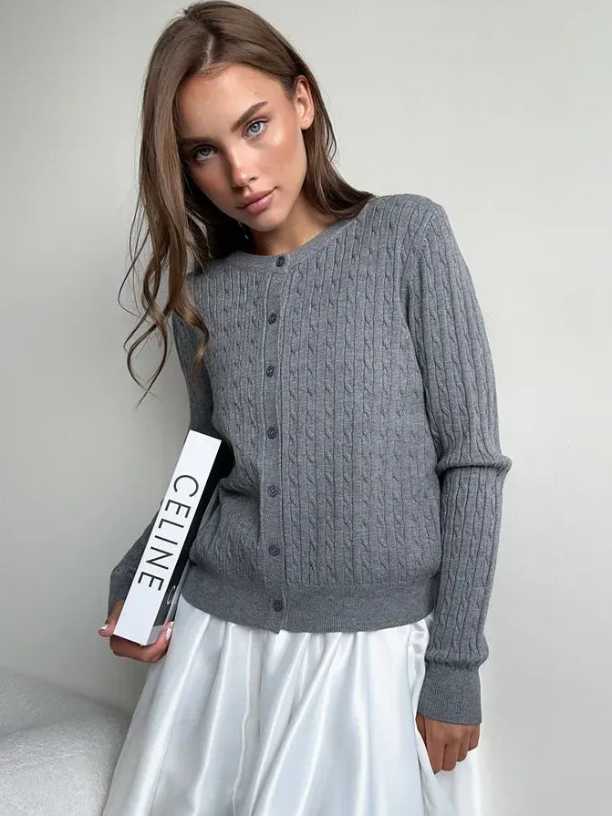 Sterling Cardigan by Lauven in lightweight grey viscose blend with cable knit detail, styled with a chic white skirt.