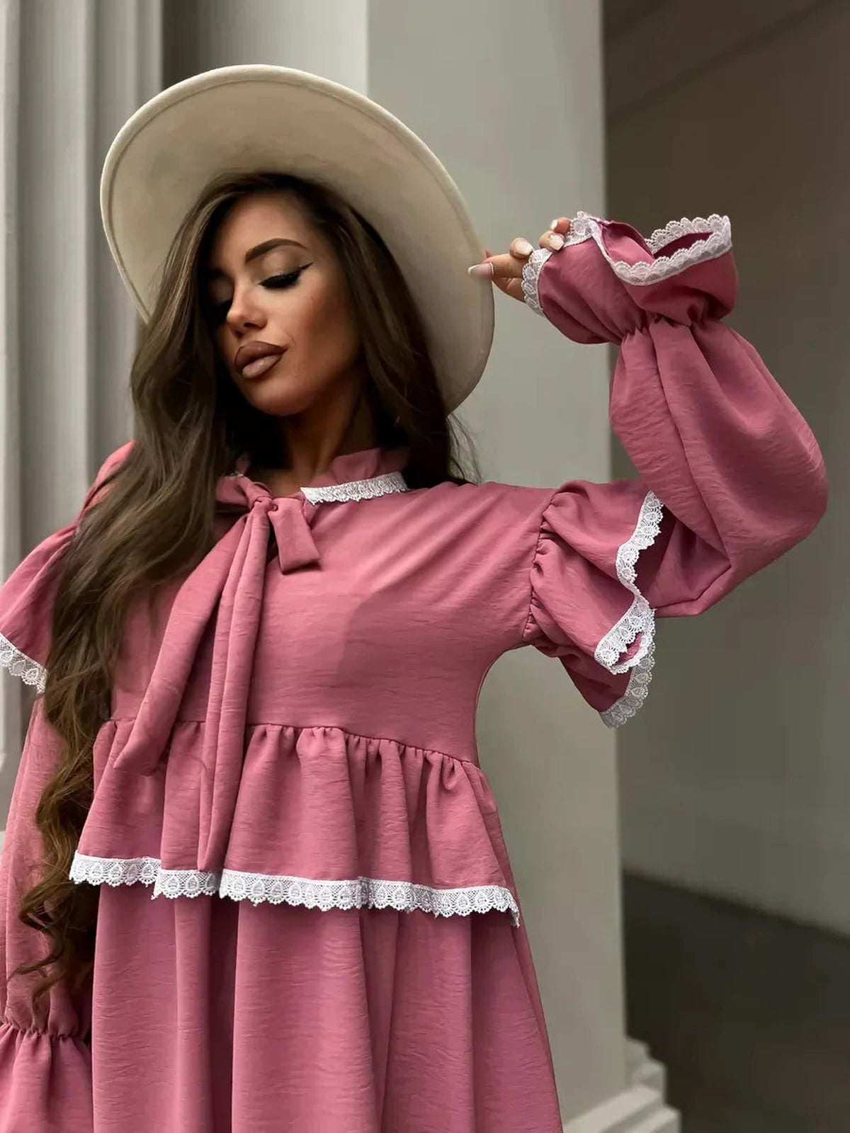 Rosea Mini Dress by Lauven featuring elegant ruffles, lace detail, and a stylish wide-brim hat, exuding feminine sophistication.