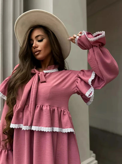 Rosea Mini Dress by Lauven featuring elegant ruffles, lace detail, and a stylish wide-brim hat, exuding feminine sophistication.