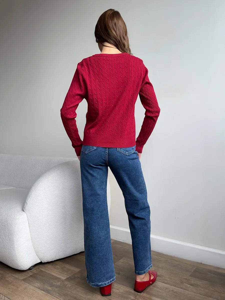 Sienna Cardigan by Lauven modeled from the back in dark red knit paired with blue jeans.