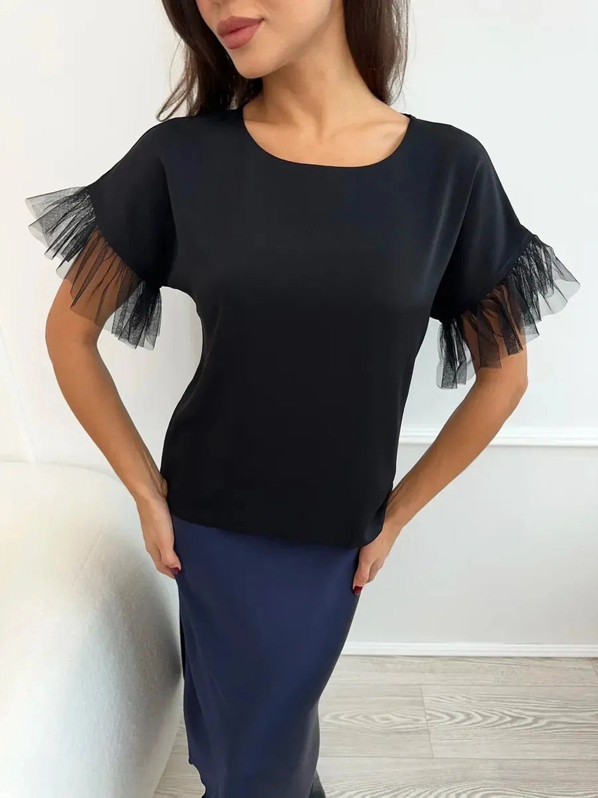 Noiré Blouse by Lauven - Elegant black blouse with tulle ruffle detail, showcasing modern femininity.