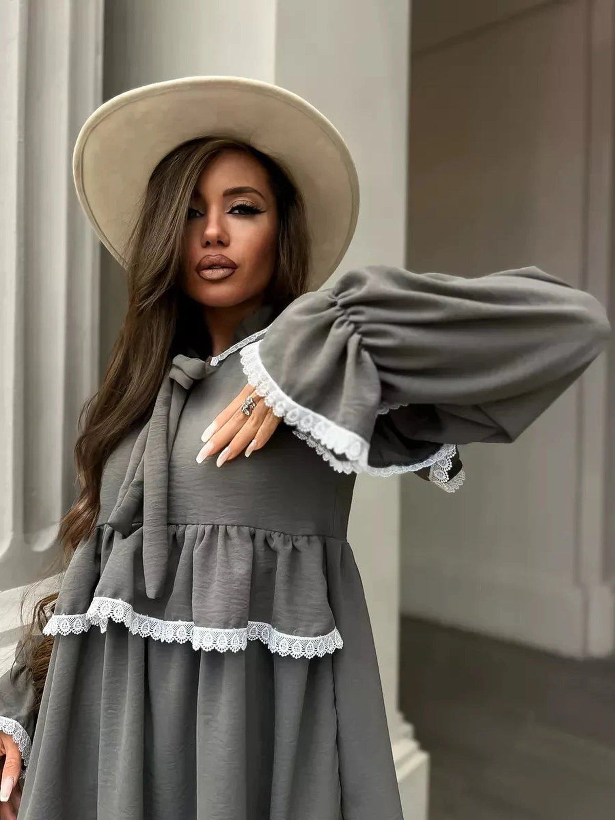 Luna Mini Dress by Lauven features an elegant ruffled design and lace trim, perfect for stylish occasions.