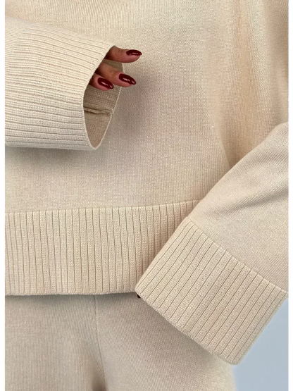 Close-up of the Eterna Sweater from Lauven, showcasing the light beige oversized knit texture and ribbed details.
