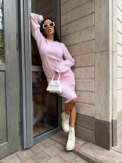 Model wearing the Luna Midi Dress by Lauven, a textured knit sweater dress in soft pink, styled with trendy accessories.