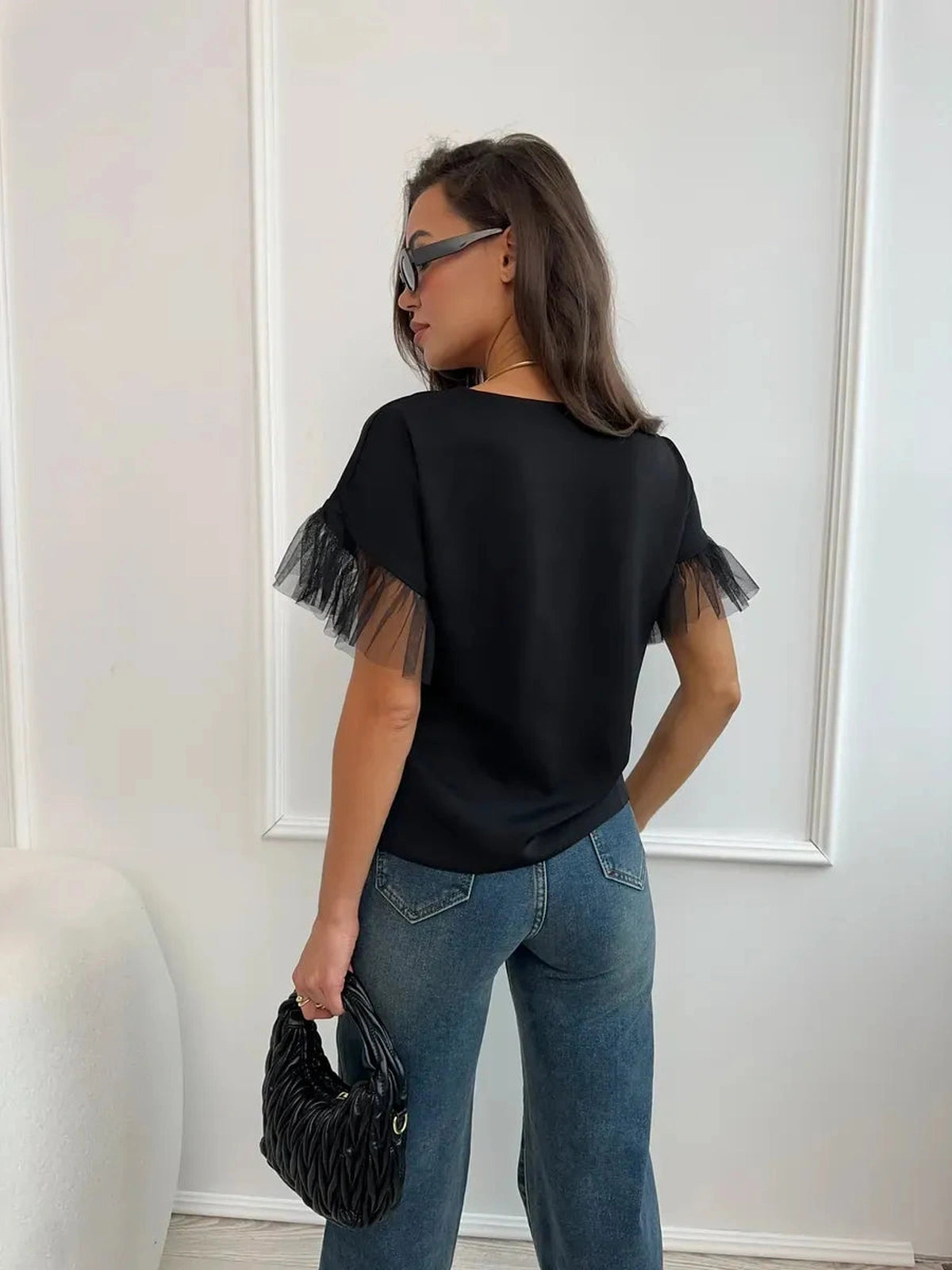 Noiré Blouse by Lauven, elegant black blouse with tulle ruffle detail, perfect for warm seasons.