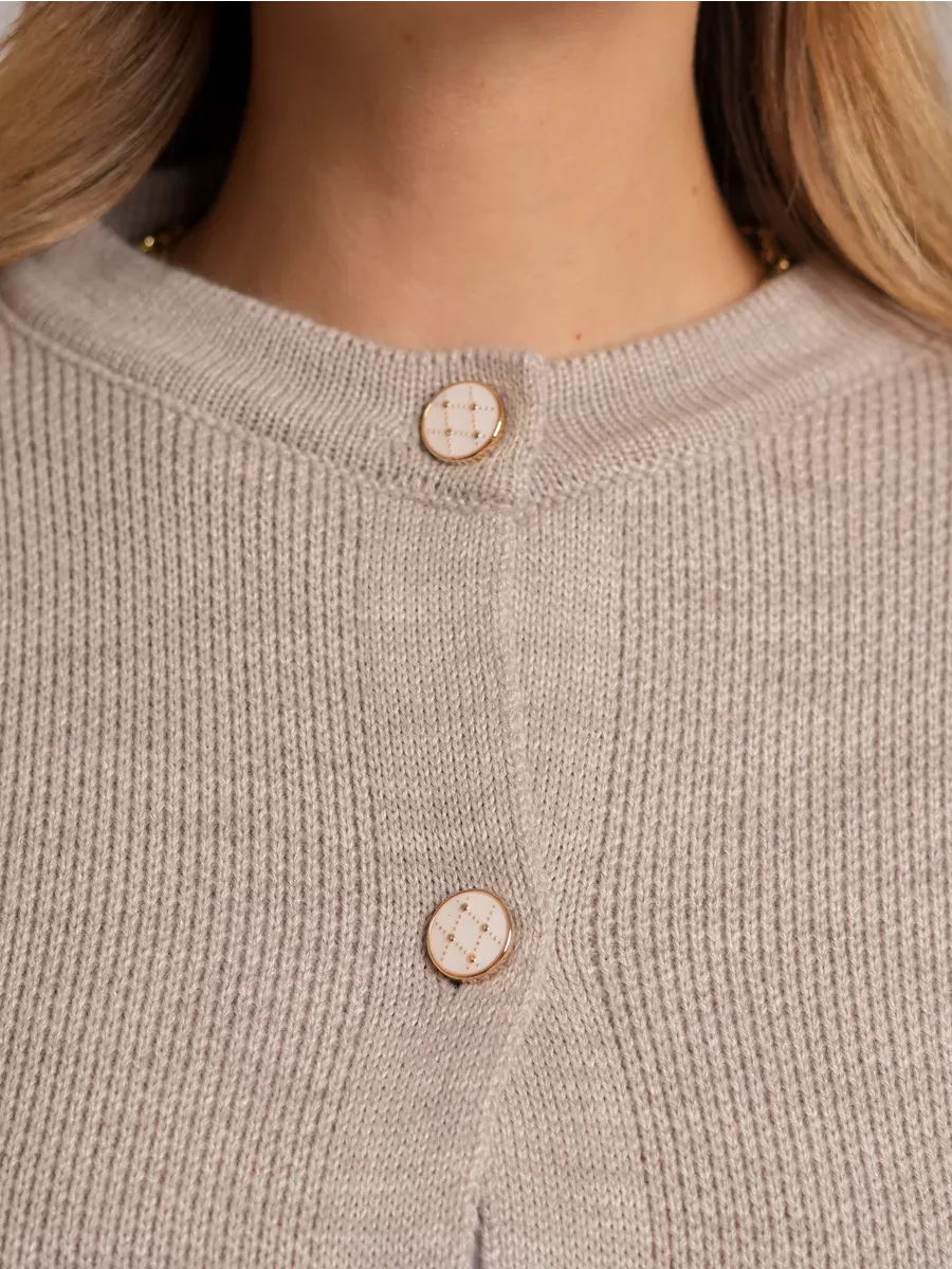 Alba Cardigan by Lauven featuring decorative buttons and a soft beige knit design.