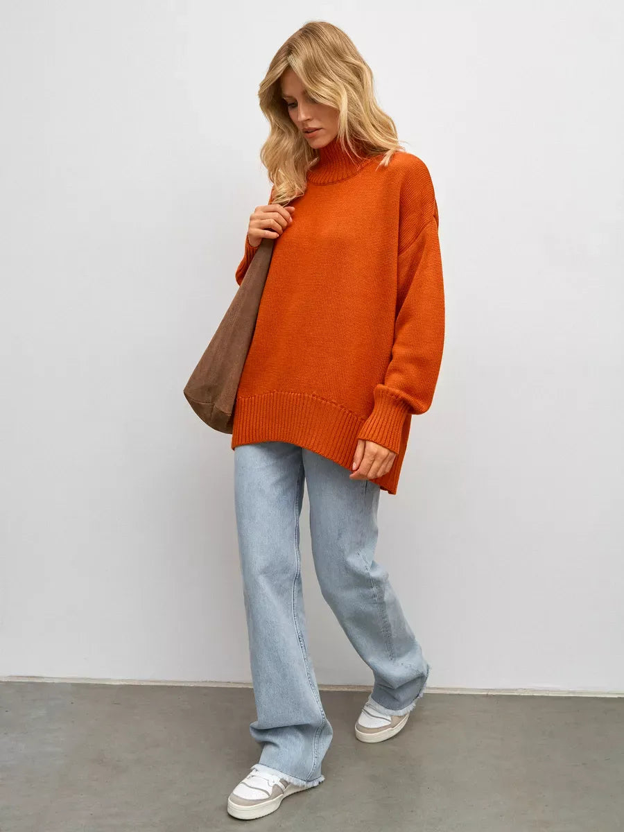 Model wearing the Ember Sweater in terracotta by Lauven, showcasing its oversized fit and cozy turtleneck design.