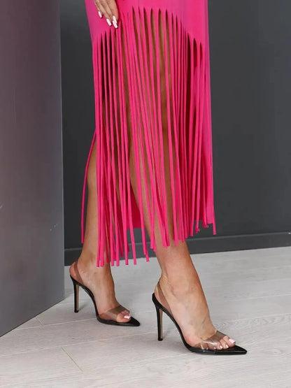 Capri Midi Dress detail featuring trendy fringe hem in fuchsia, styled with chic black heels by Lauven.