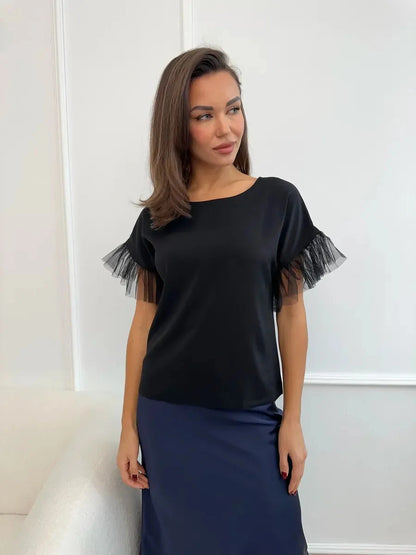 Noiré Blouse from Lauven — Elegant short sleeve black blouse with tulle ruffle detail.